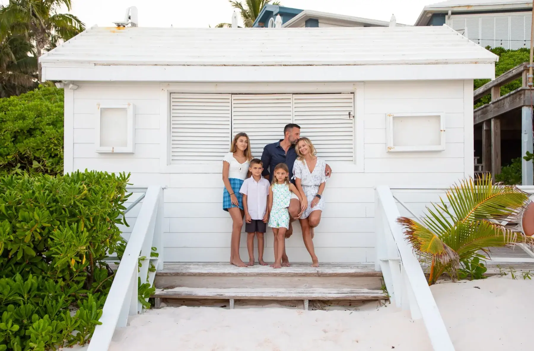 The Lockwood family in front of a white beach building