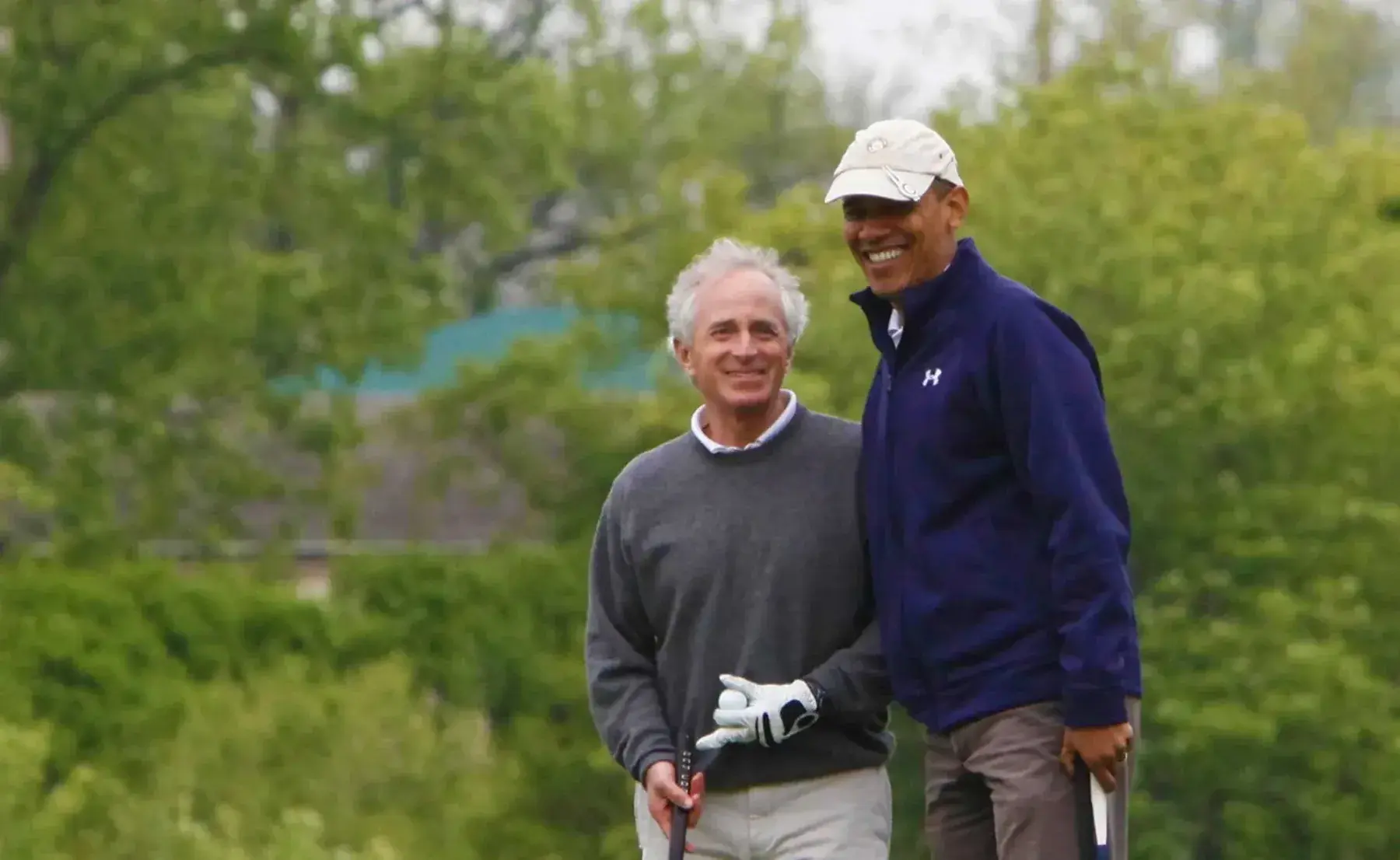 A golfer beside President Obama on the course
