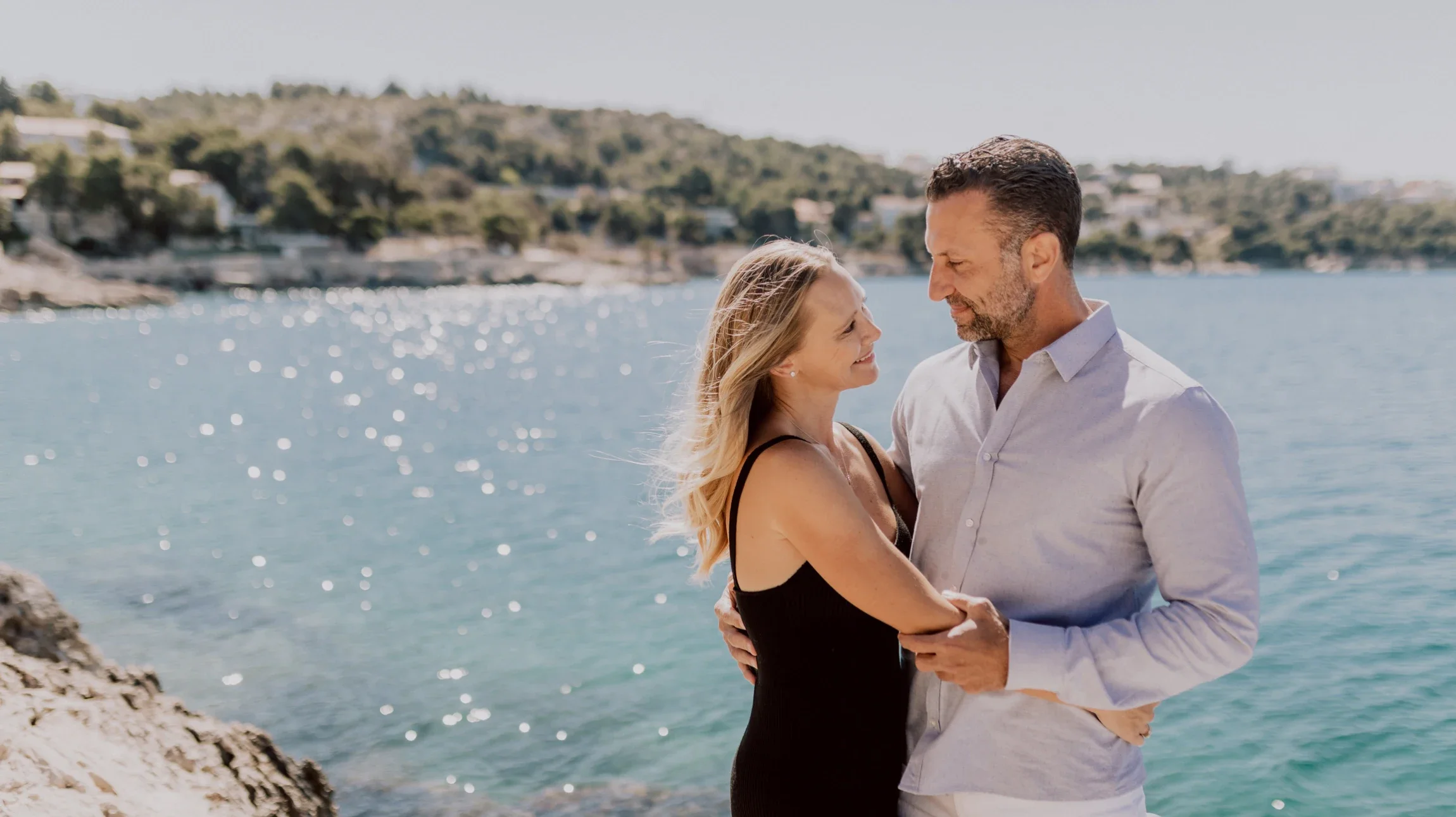 Phil and Erin on the rocks above a sparkling Adriatic cove in Croatia