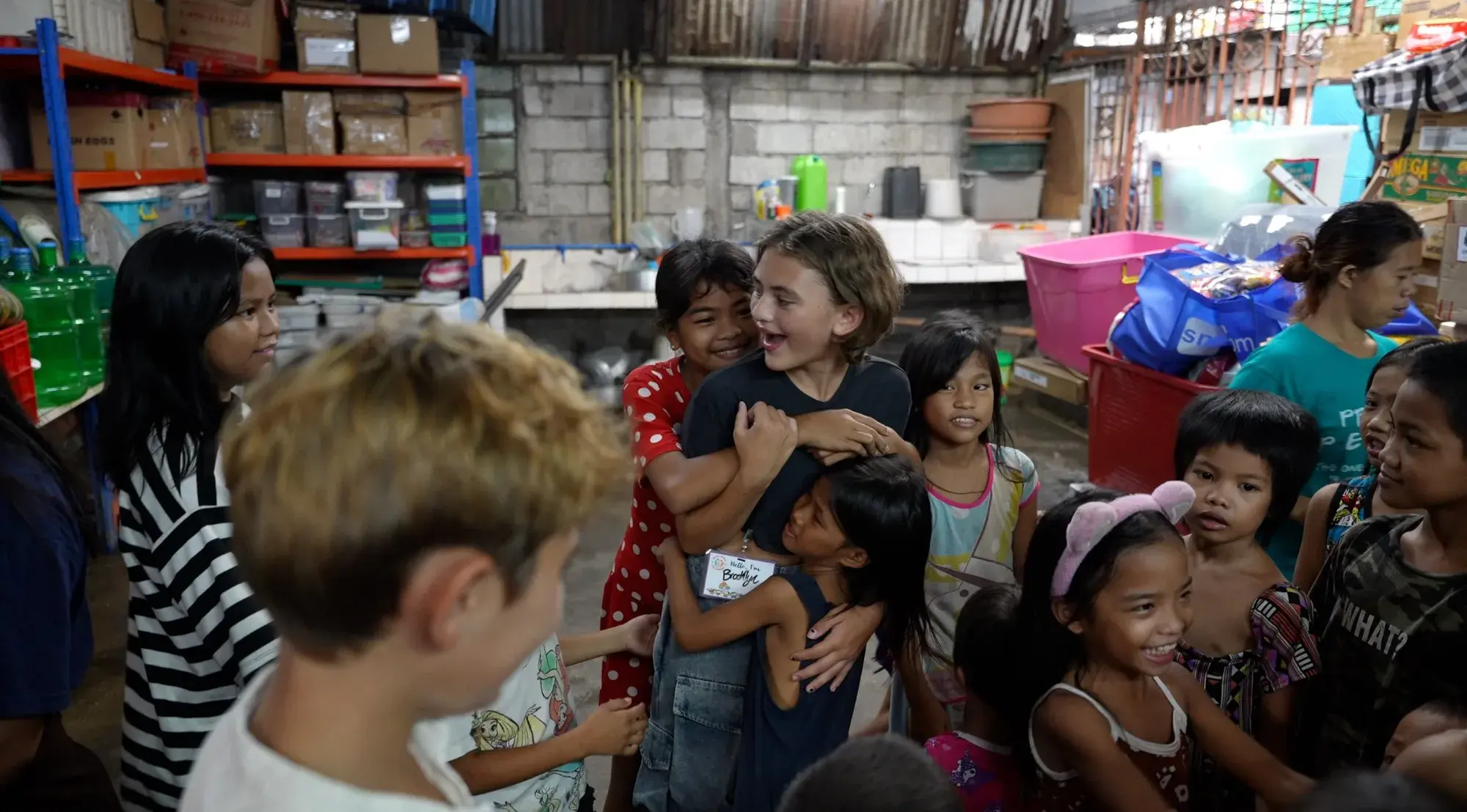 Brooklyn Lockwood hugging children at a Project PEARLS center in the Philippines
