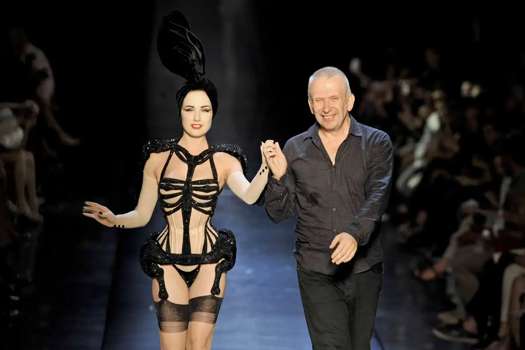 A designer and model on the runway