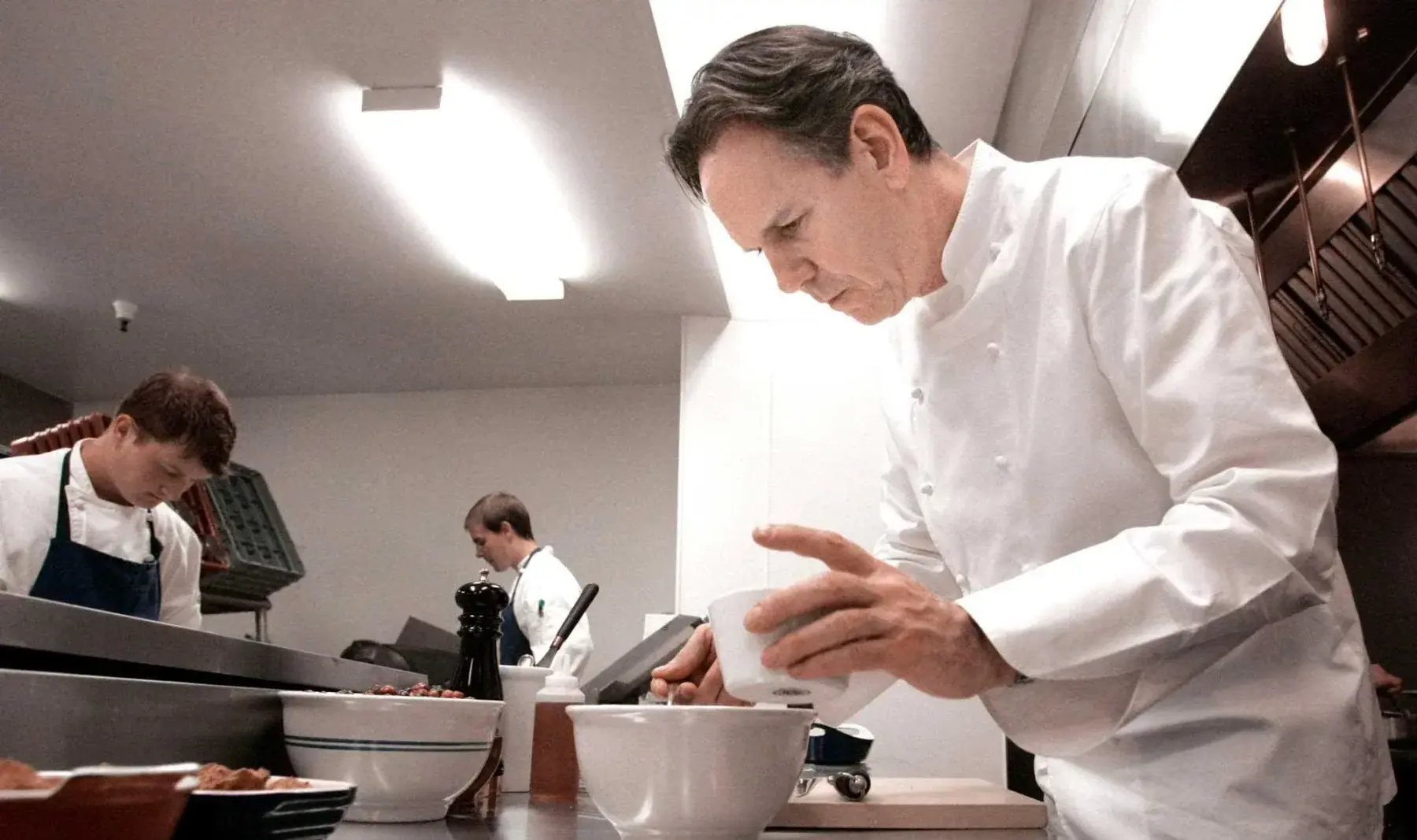 A chef plating in a restaurant kitchen