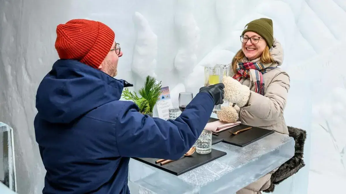 A couple clink glasses at the Hotel de Glace in Quebec City