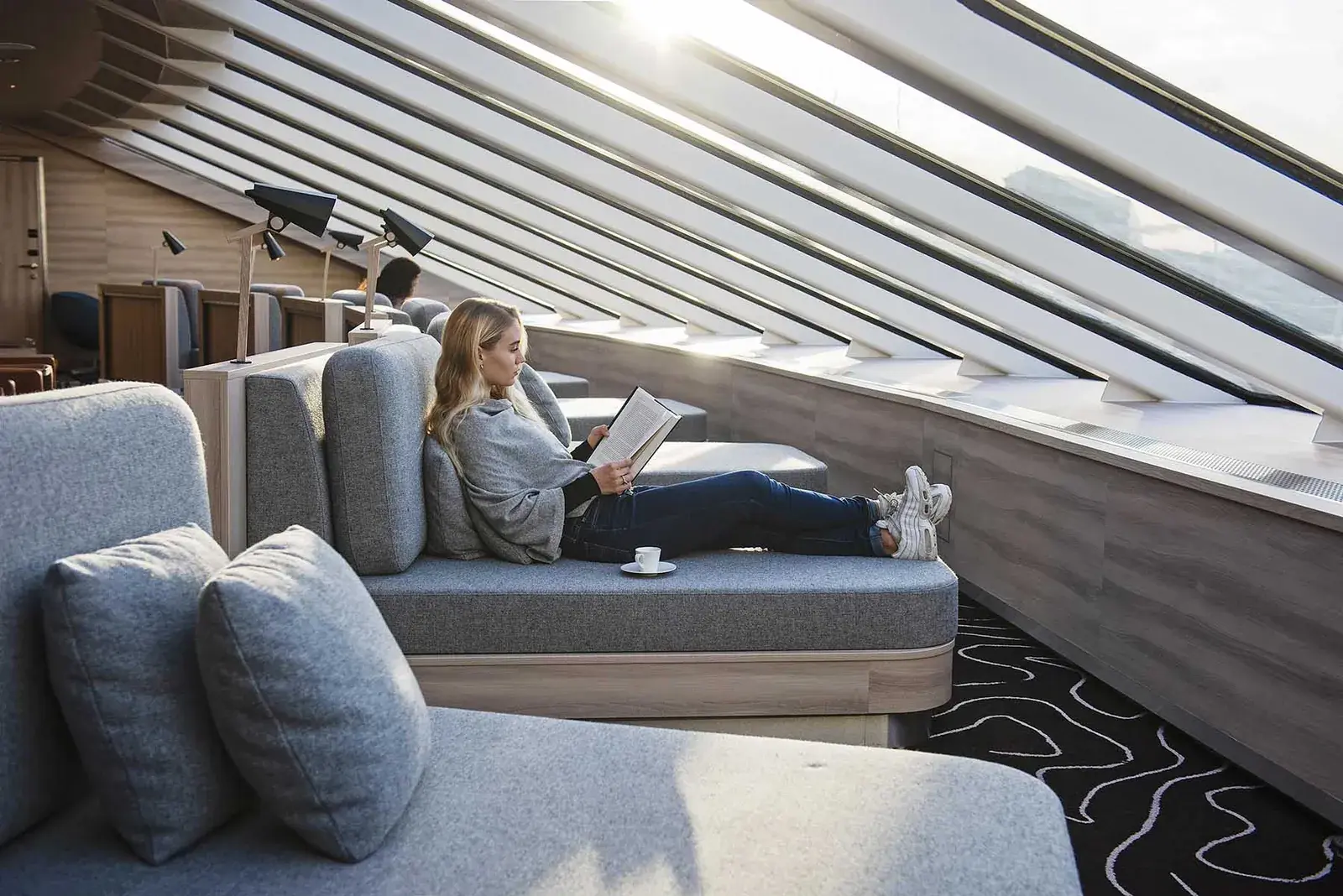 Woman lounging in an observation deck on hx ms fridtjof nansen