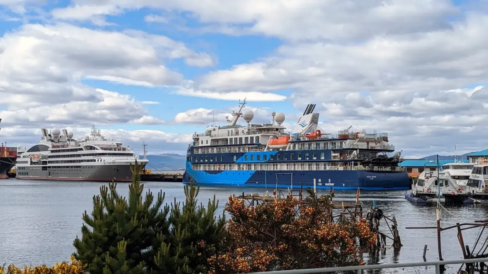 Two expedition cruise ships sit in a port in Ushuaia