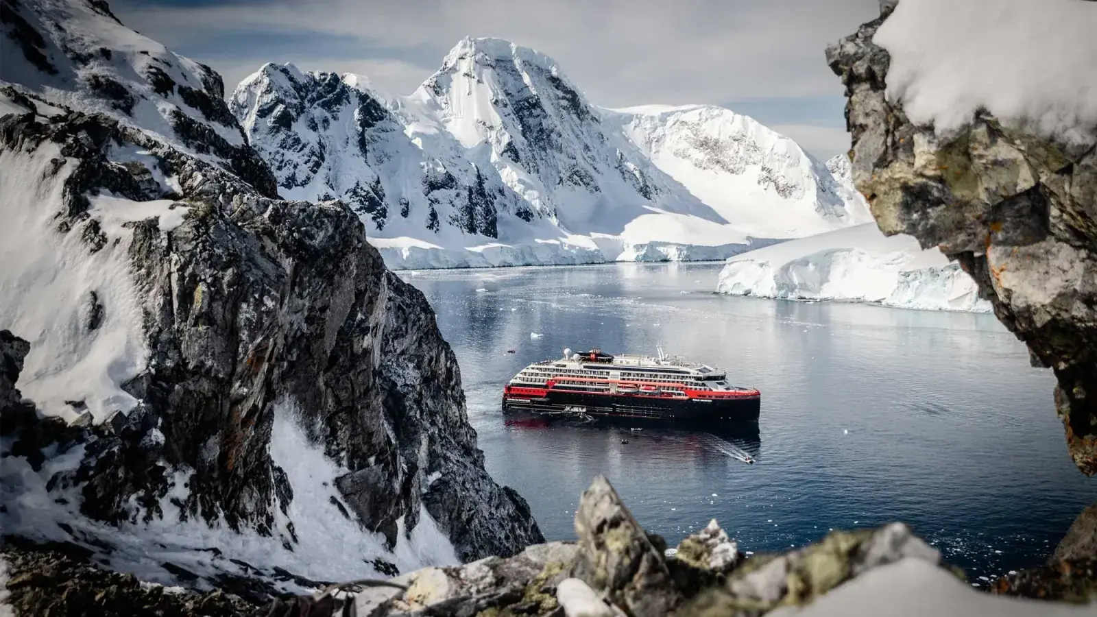 An HX Expeditions cruise ship sails through polar fjords