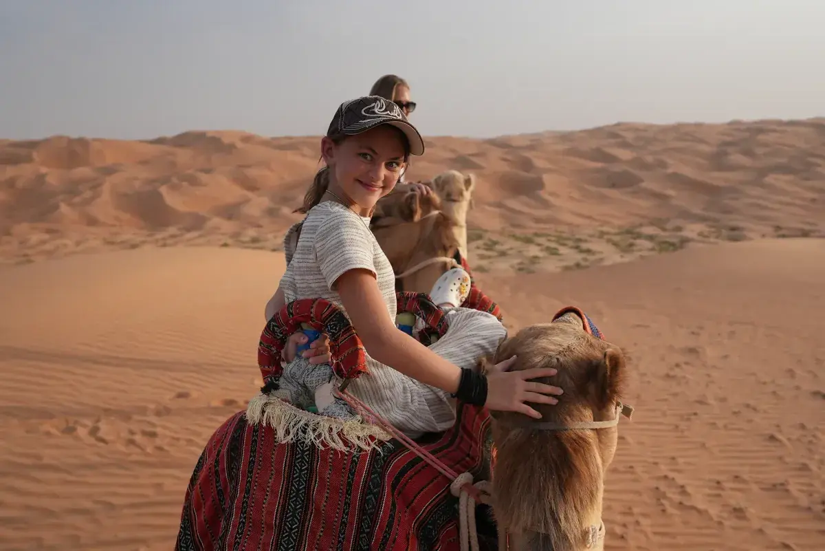 Brooklyn Lockwood makes a funny face while riding a camel through the UAE