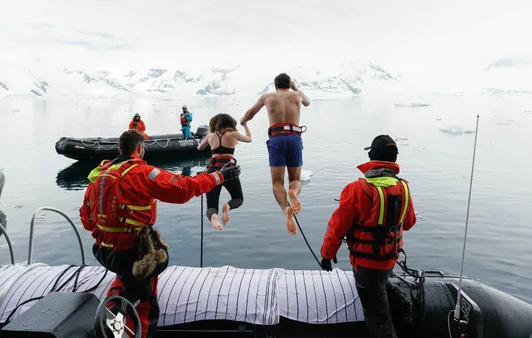 People taking the polar plunge in Antarctica