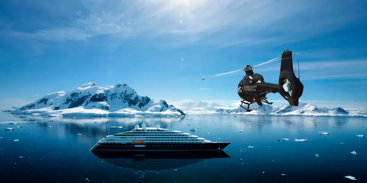 A helicopter approaches the Scenic Eclipse super yacht