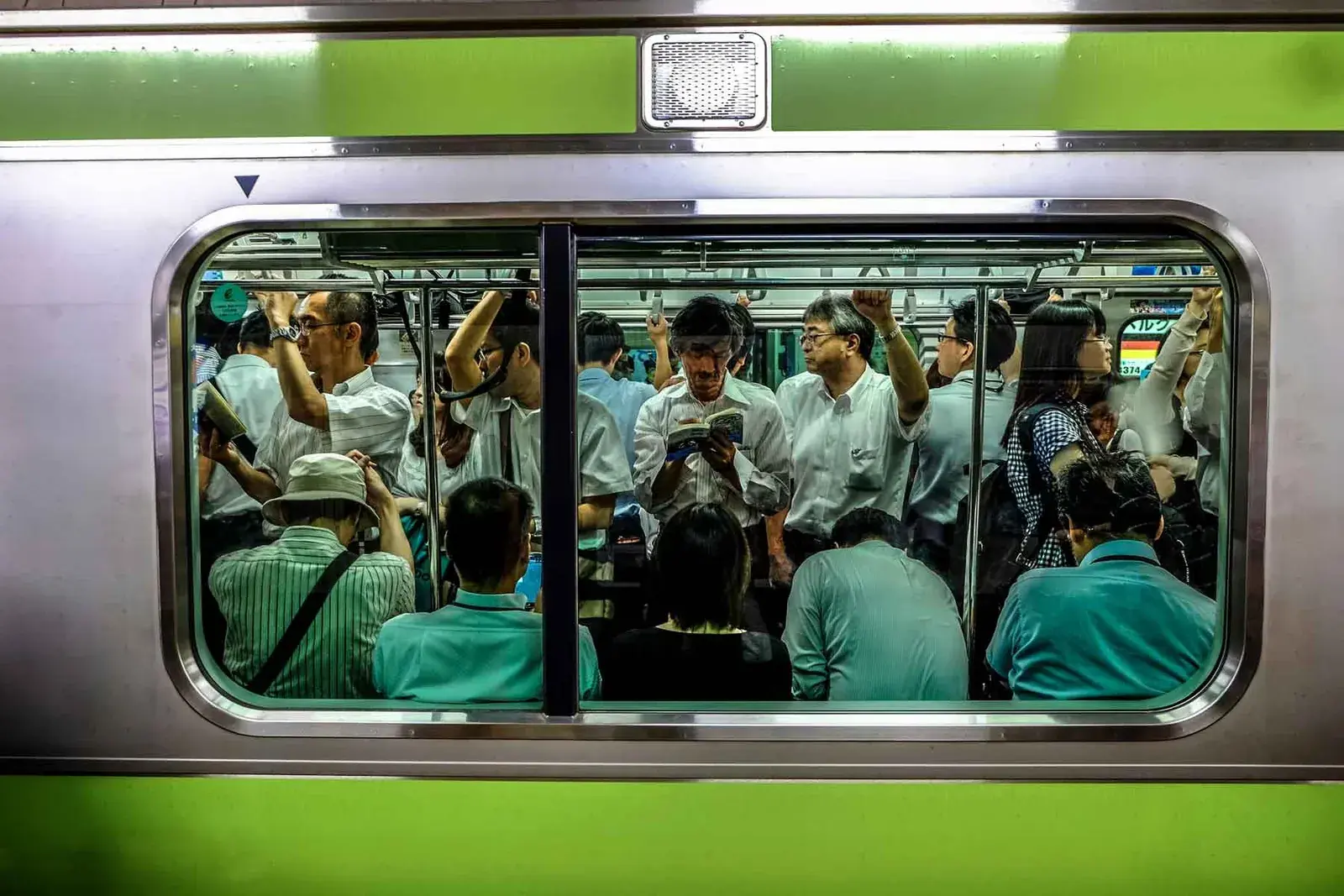 Looking through a window of a crowded subway train