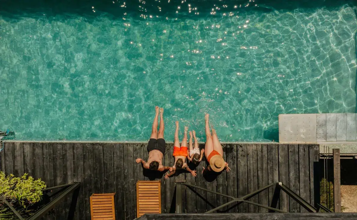 Birds eye view of people dipping their feet in a pool