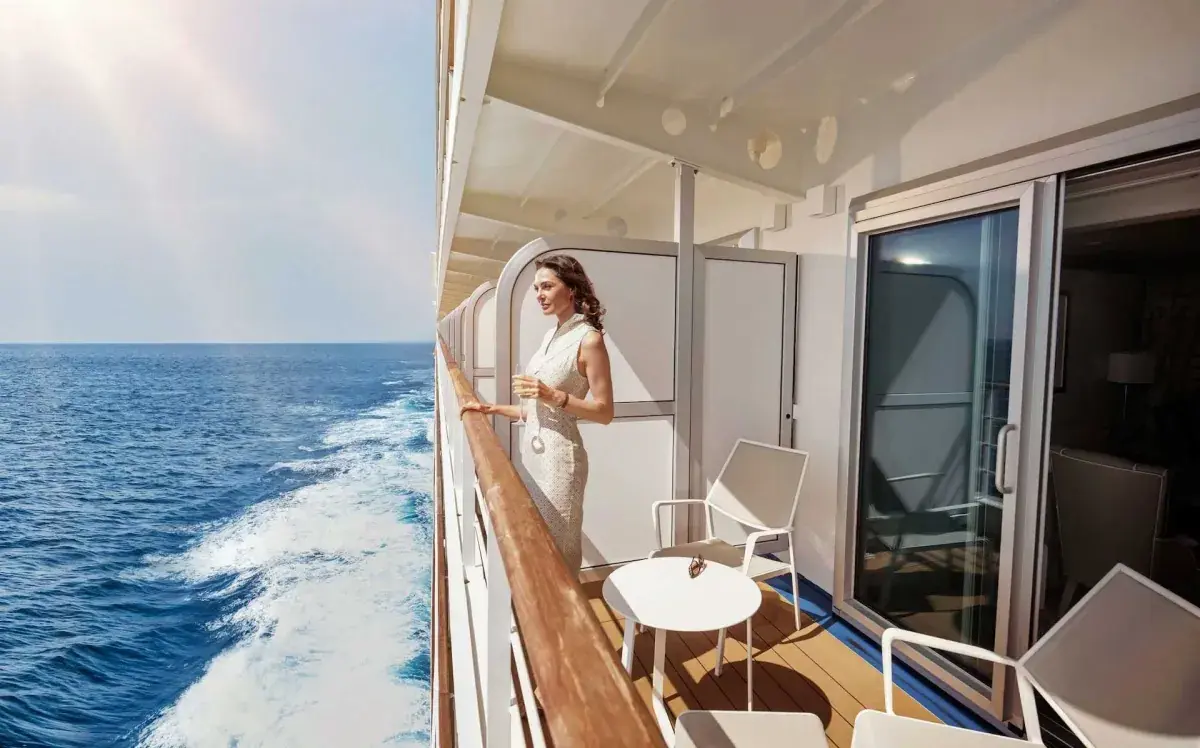 A woman stands on a Silversea cruise ship veranda