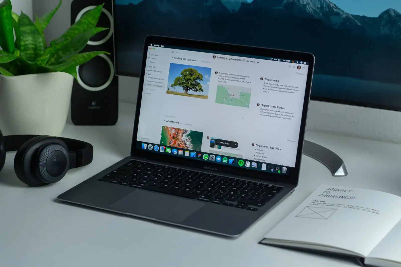 A laptop computer sits on a desk with travel content displayed