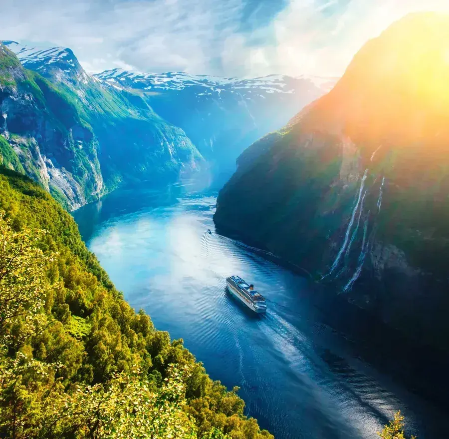 A cruise ship sails through fjords of Norway