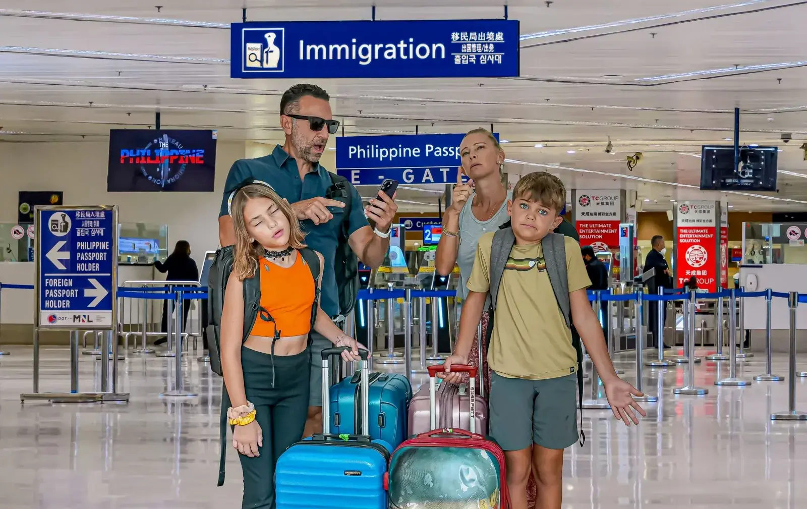 The Lockwood family in an airport terminal, looking confused