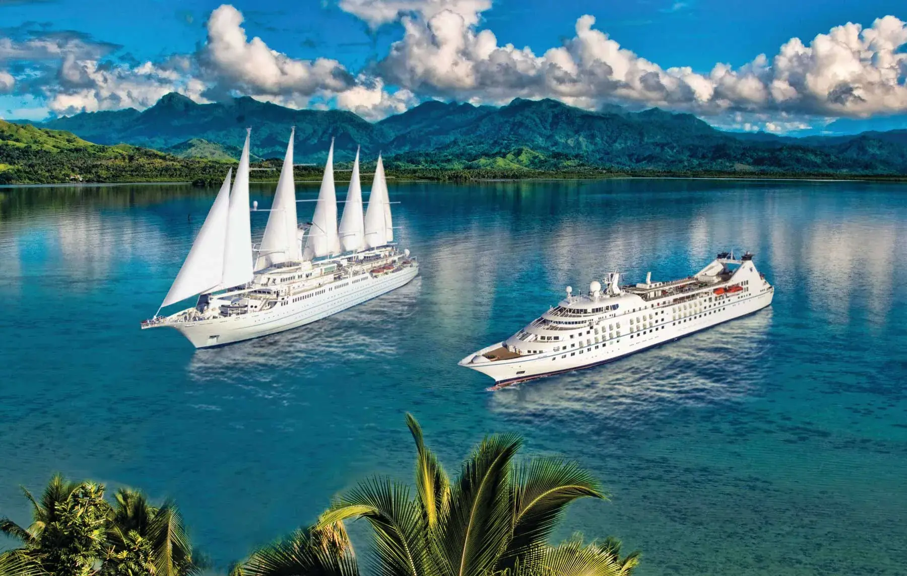 Two Windstar yachts anchored together in a tropical bay