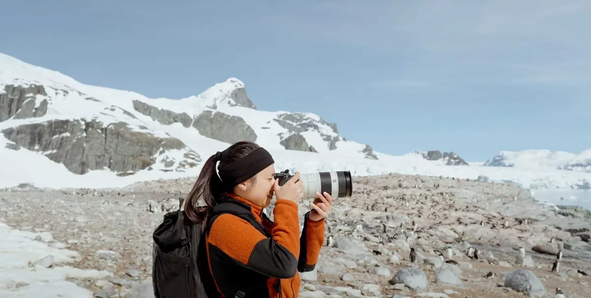 Sarah Afiqah Rodgers taking photos in Antarctica