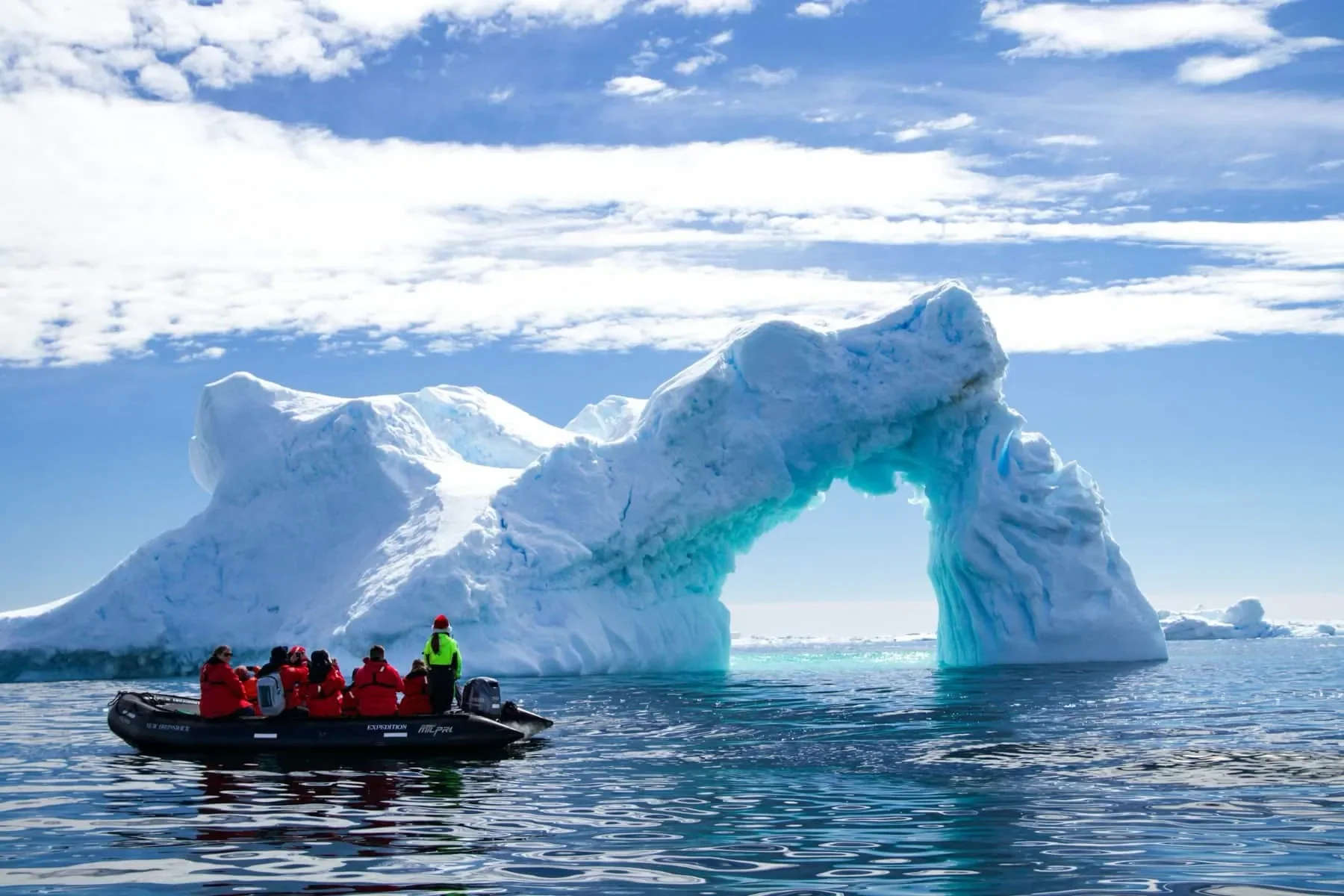 A Zodiac cruises past icebergs in Antarctica