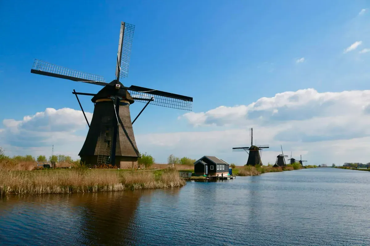 Windmills along water in Holland