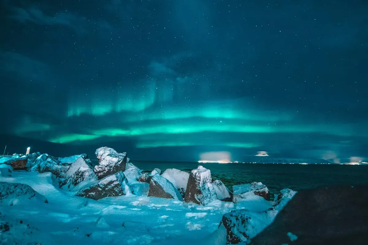 Iceland at night with Northern Lights in the sky