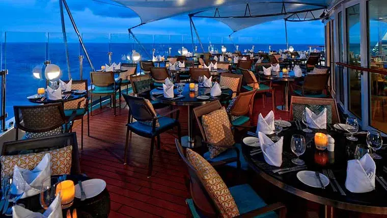 Candles al fresco restaurant on Windstar Star Breeze deck at dusk