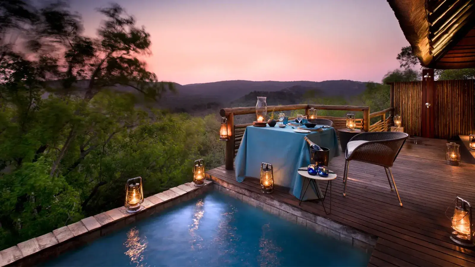A pool and sunset at an &Beyond lodge