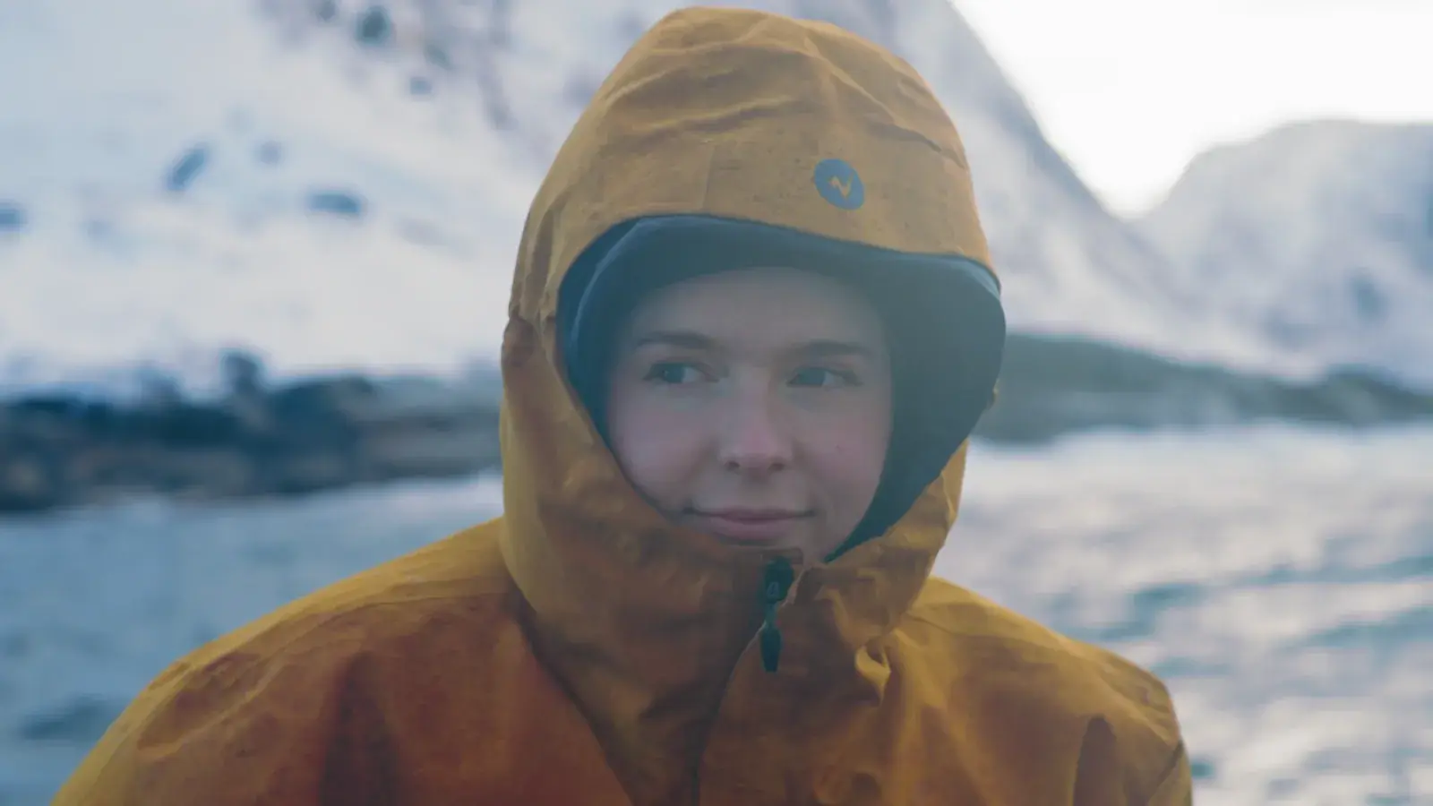 Traveler bundled in a heavy parka on deck in the Arctic cold