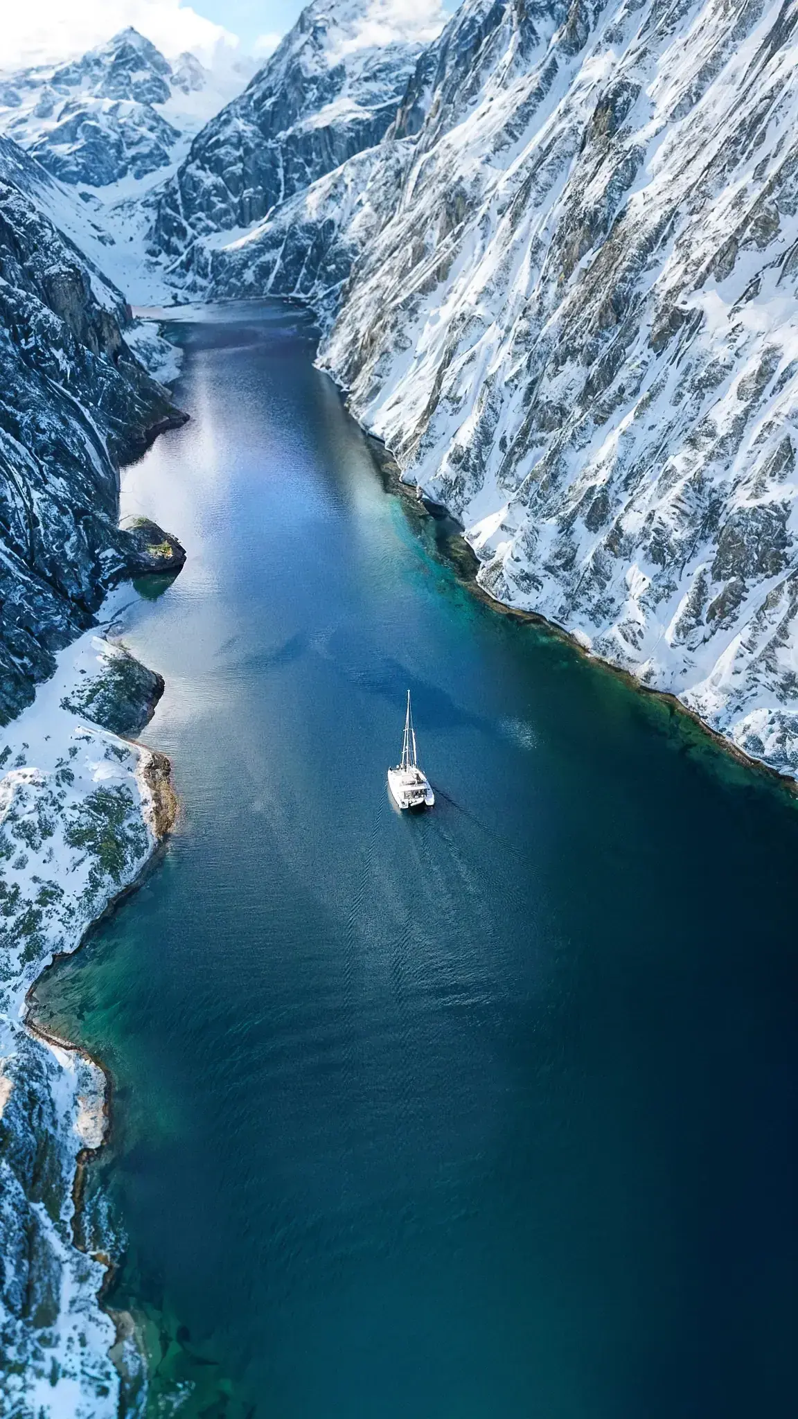 Aerial view of the Arctic Dream catamaran anchored in a Norwegian fjord