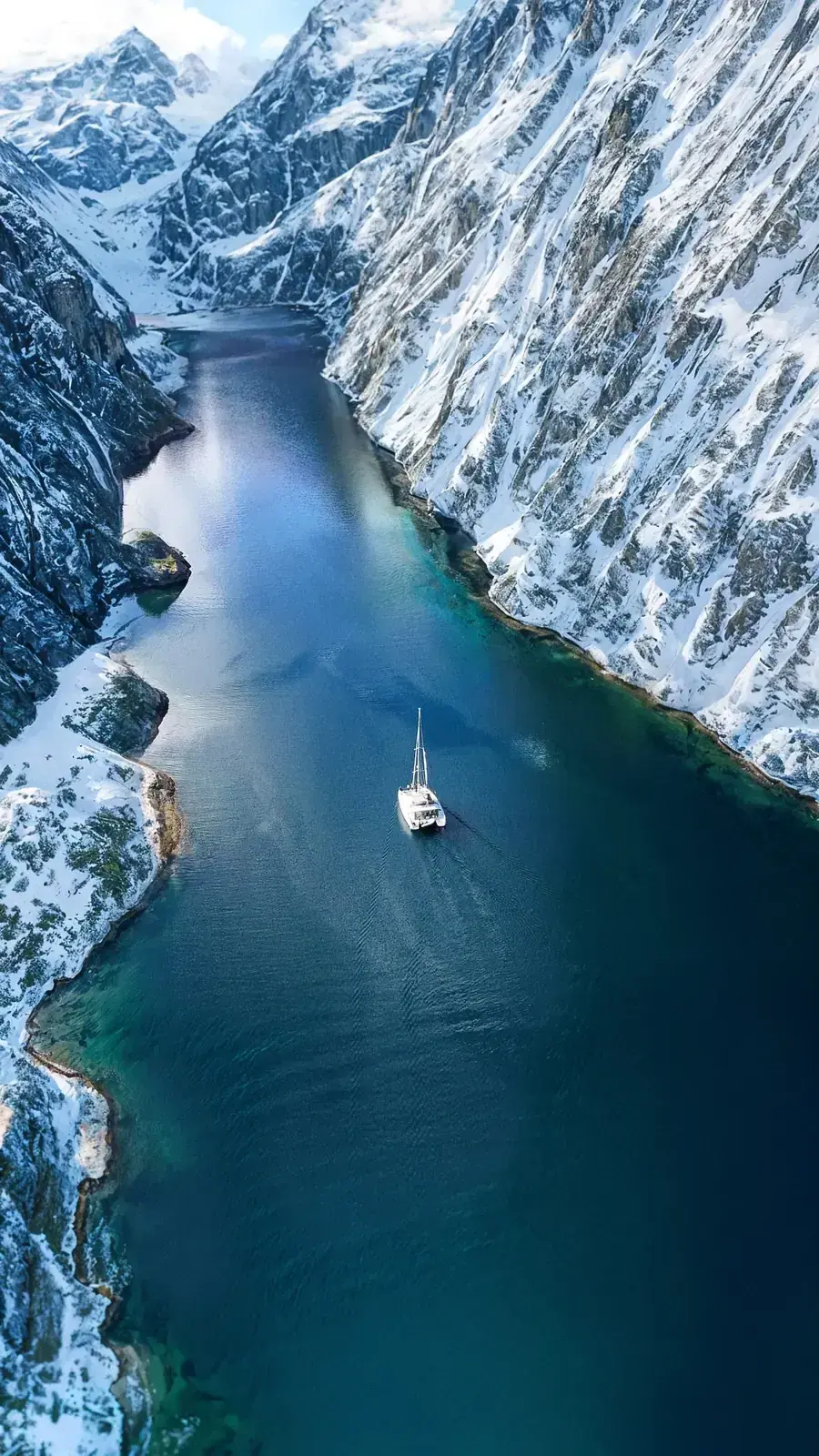 Aerial view of the Arctic Dream catamaran anchored in a Norwegian fjord