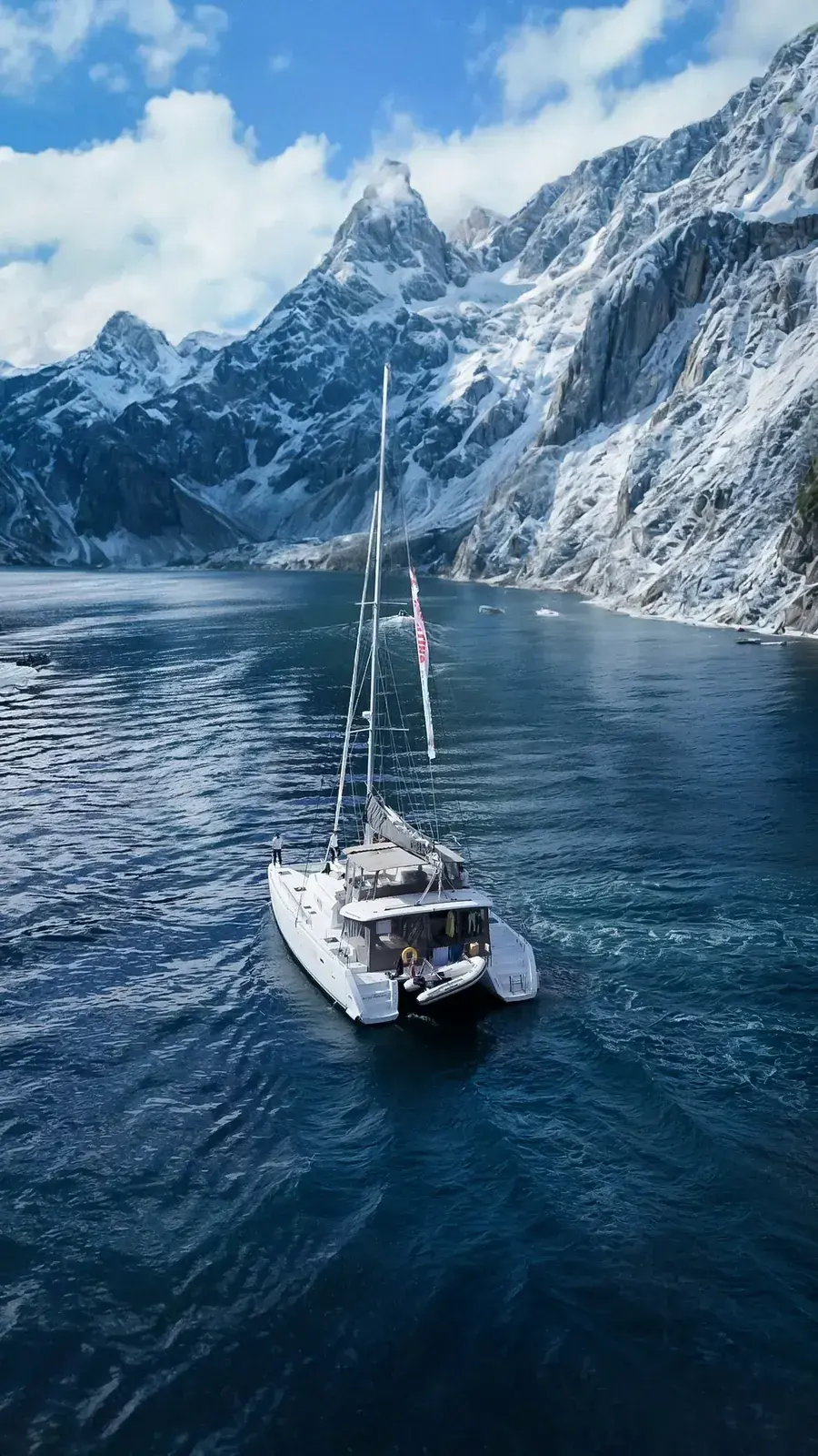 Aerial view of the Arctic Dream expedition catamaran on Arctic waters