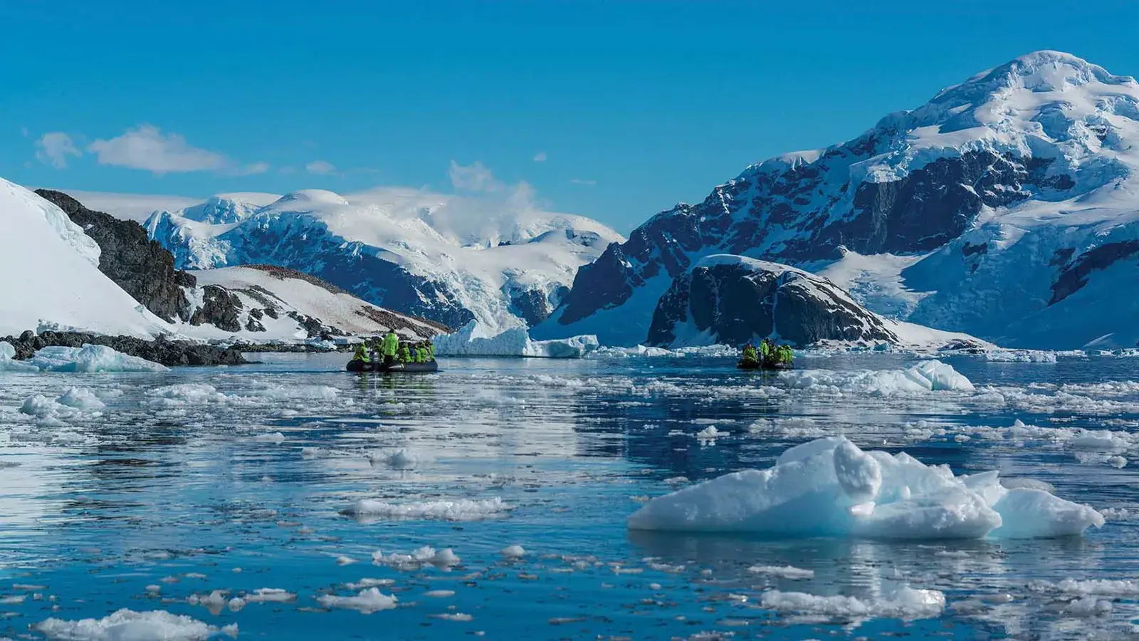 A zodiac travels through ice in Antarctica