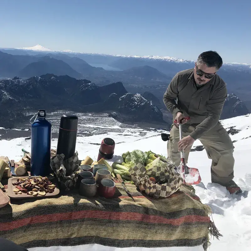 A man prepares an outdoor meal at &Beyond Vira Vira