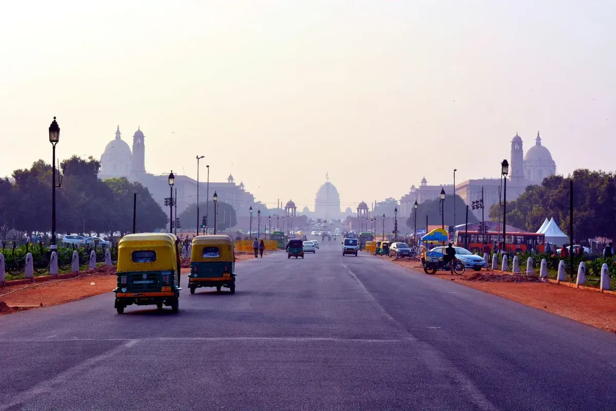 Trikes driving down a street in New Delhi