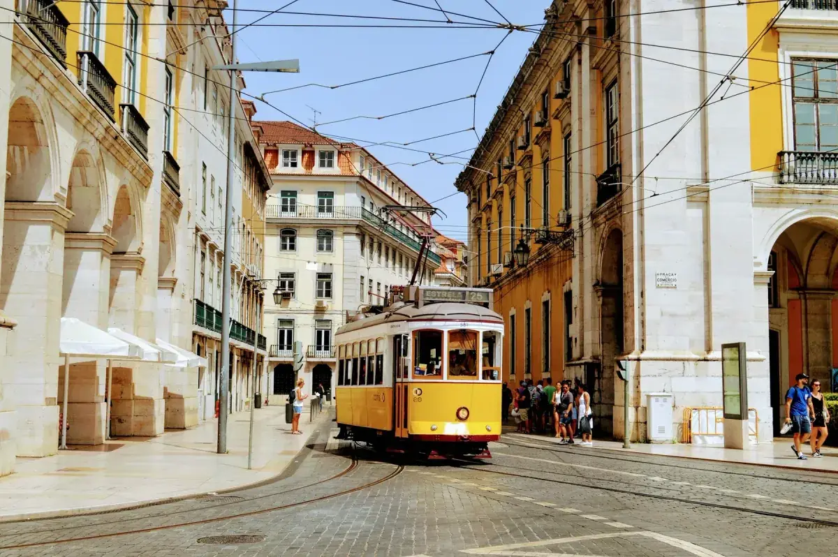A cable car runs through the city streets in Lisbon, Portugal