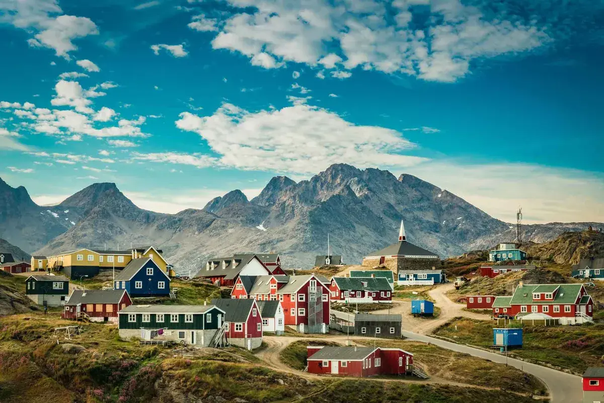 Colorful homes sit on a mountainside in Greenland
