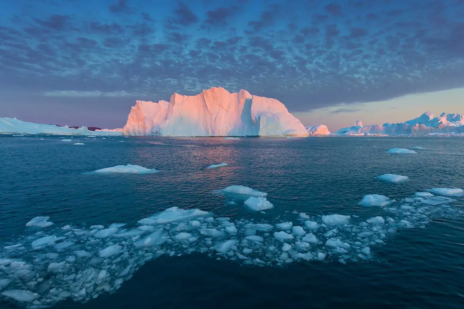 Iceberg at golden Arctic sunset