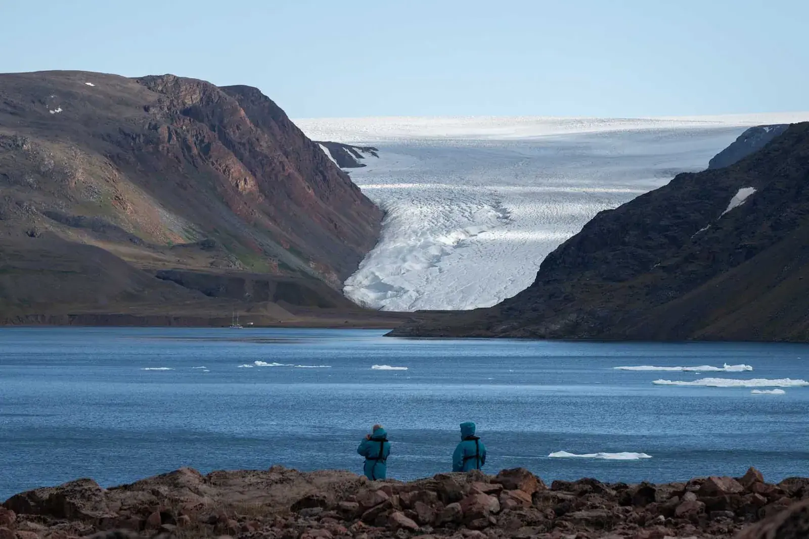 Two men overlooking a Greenland glacier