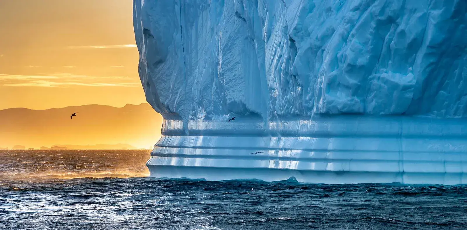 Sculpted iceberg glowing at sunset in Arctic Greenland