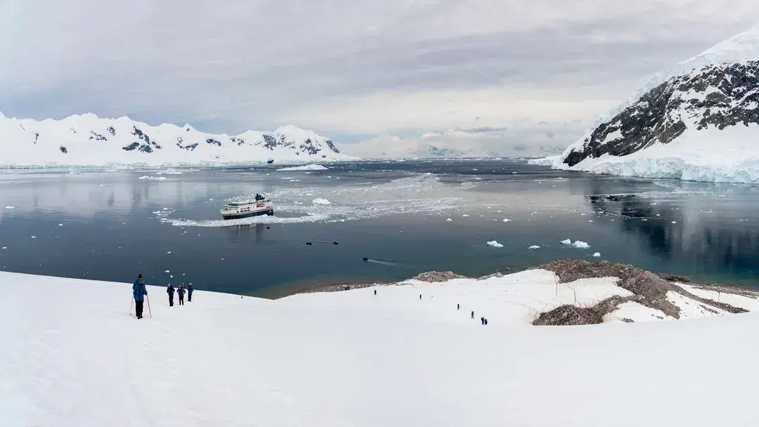 An HX Expeditions cruise ship sits in Niko Harbor Antarctica