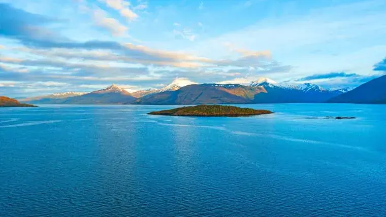 Aerial view of the blue waters and mountain backdrops in the Strait of Magellan