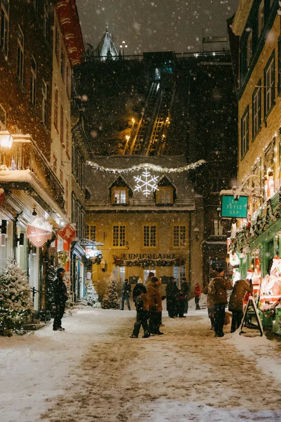 Old Quebec City street at night while snowing