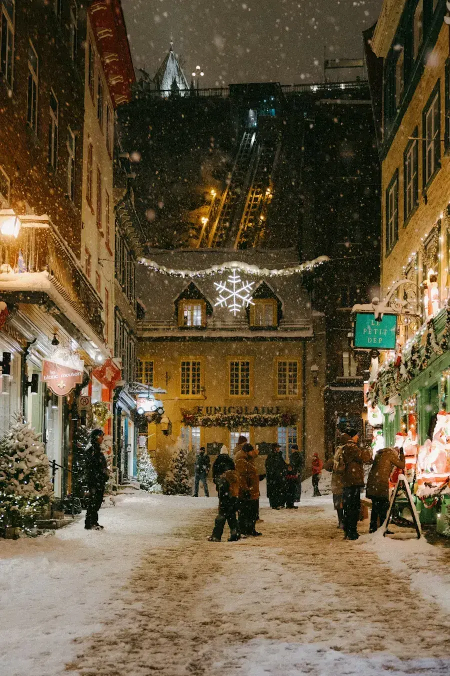 Old Quebec City street at night while snowing