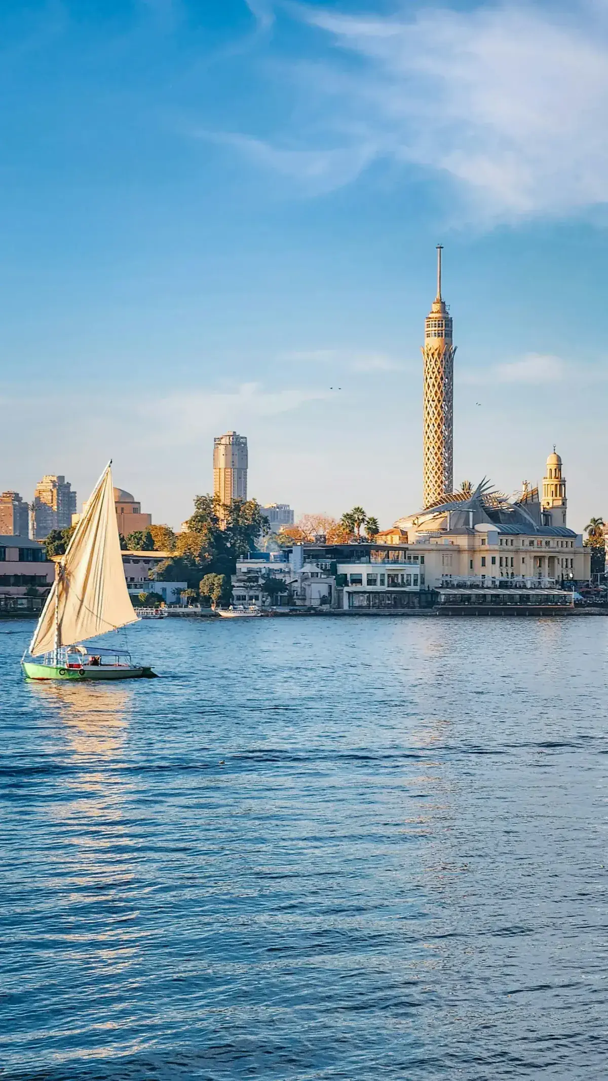 Cairo skyline with a sailboat in the Nile River