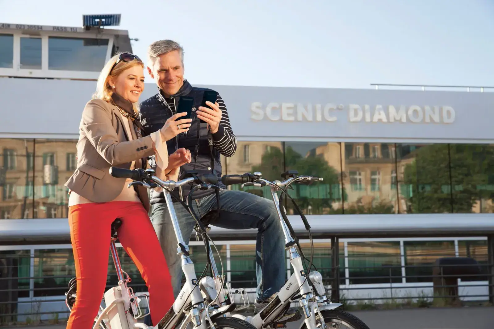 A couple sit on e-bikes