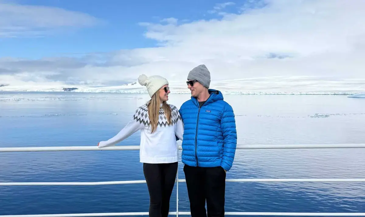 Meg and Pat of Sea2Peak, standing on a ship in Antarctica