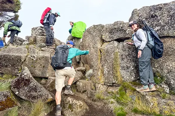 Hikers climb rocks on Kilimanjaro