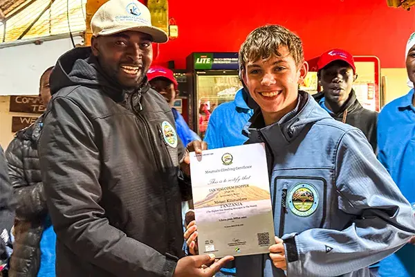 A man presents a certificate to a young man
