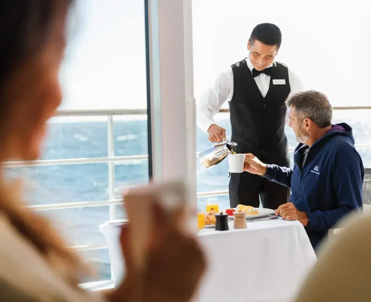A server pour coffee for passengers on a cruise ship