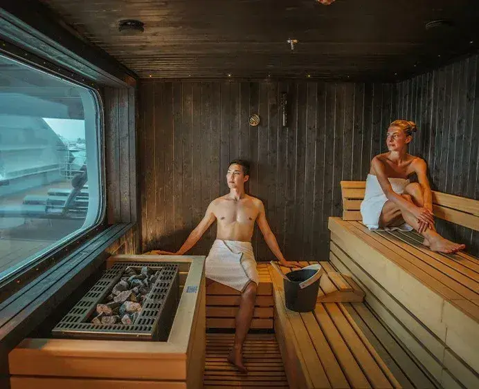 A couple relax in a sauna on a cruise ship