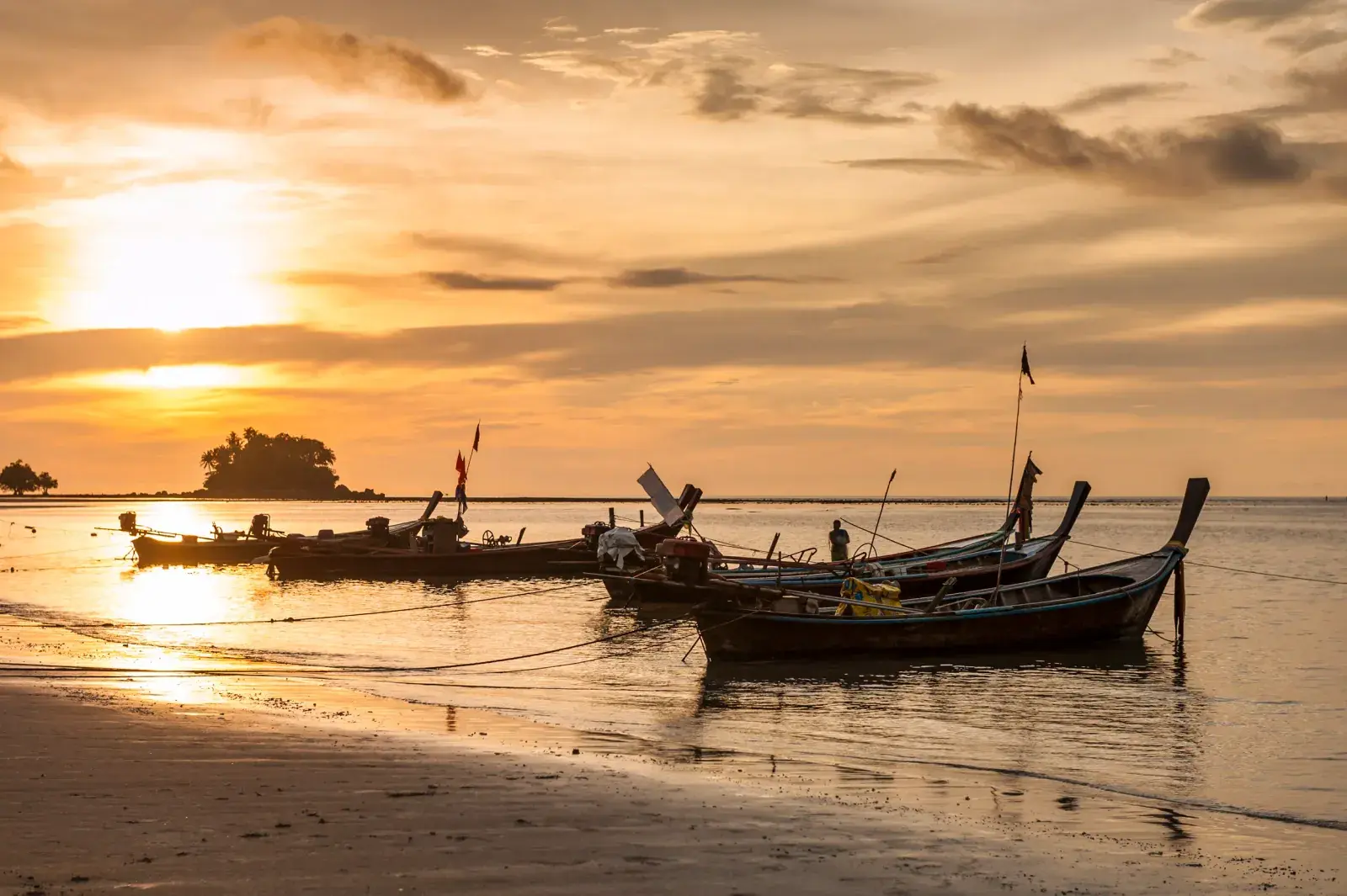 Nai yang boats on a sunset beach in Phuket